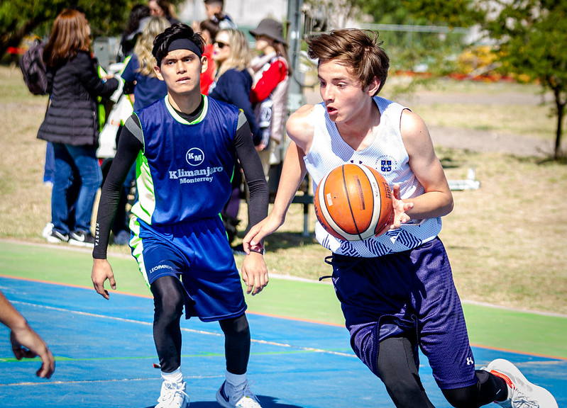 Dos jovenes jugando basquetball